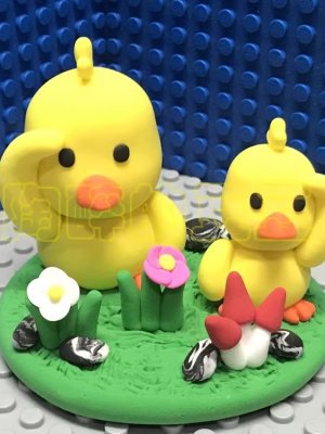 Adorable Clay Ducklings on a Meadow