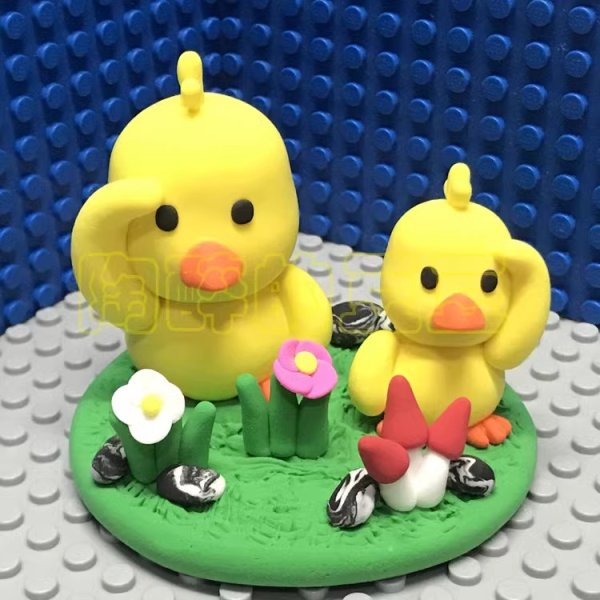 Adorable Clay Ducklings on a Meadow