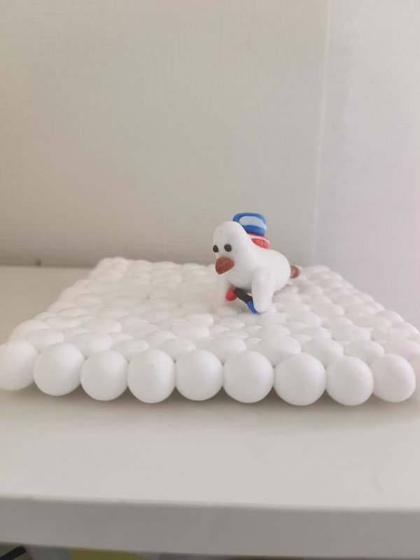 Adorable Clay Duck Lying on a Bed