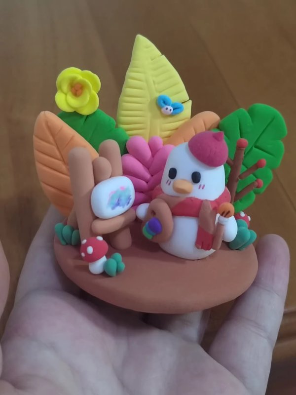 Adorable Clay Duck Engaged in Painting