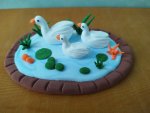 Three Graceful Clay Ducks by the Water