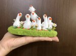 A Flock of Adorable Clay Ducks on the Grass