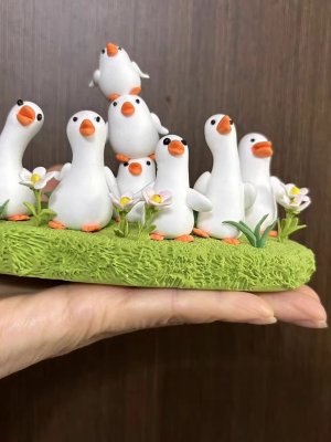 A Flock of Adorable Clay Ducks on the Grass